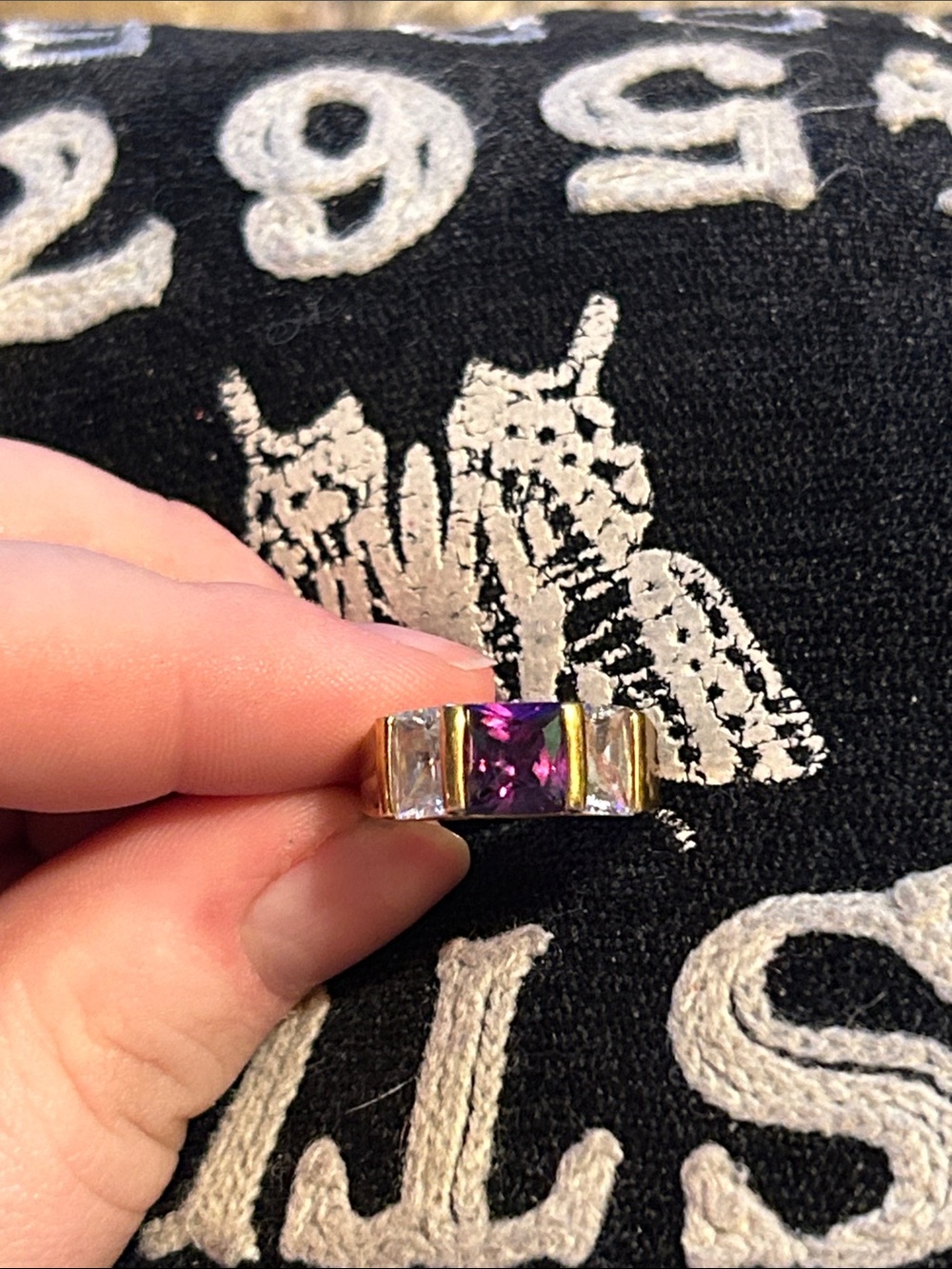 Gold Band Ring with Purple Center Stone and Clear Side Stones